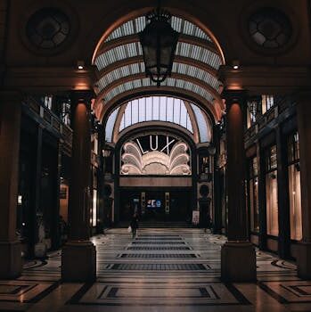 A dramatic view of a Gothic-style arcade with a 'Lux' sign and intricate architectural details.