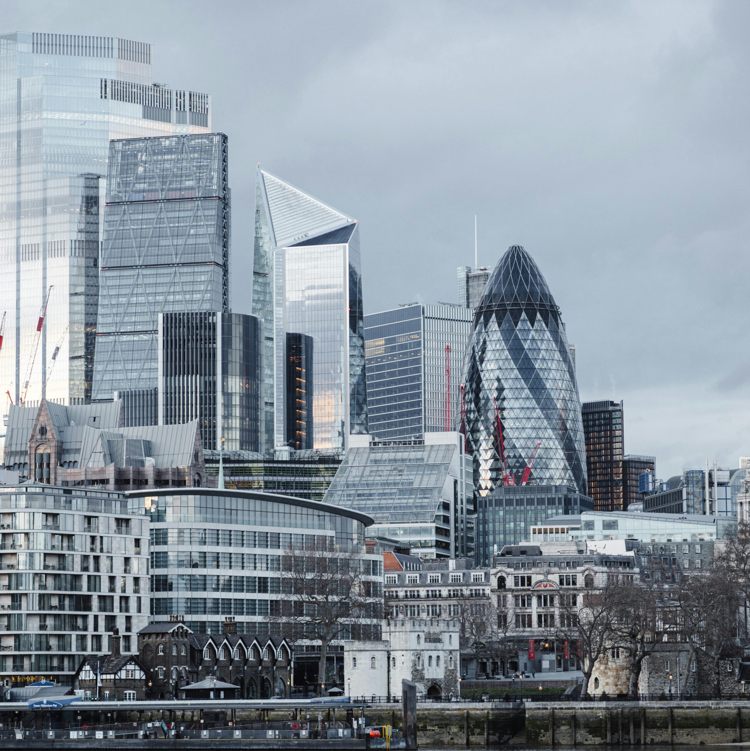 Modern multistory business centers with geometric architecture located on street against cloudy sky in downtown of London city in financial district